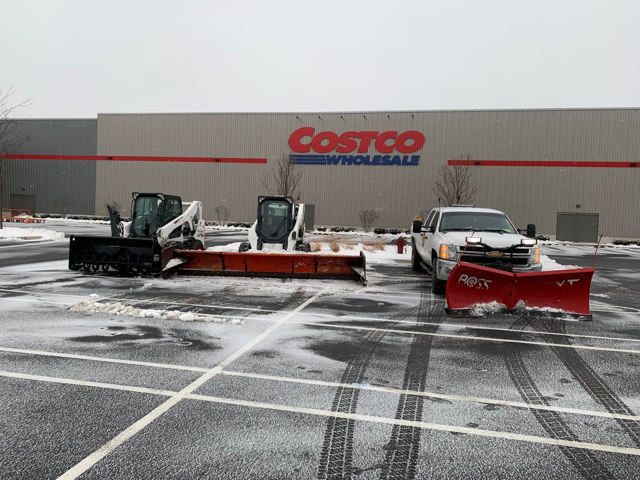 A+ Tree & Snow Removal snow plows clearing the Costco parking lot